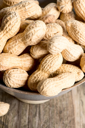 Peanuts in shell on wooden table