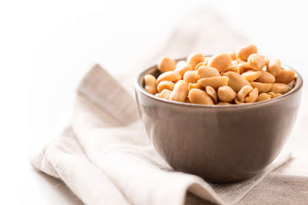 Processed peanuts in a bowl on tablecloth