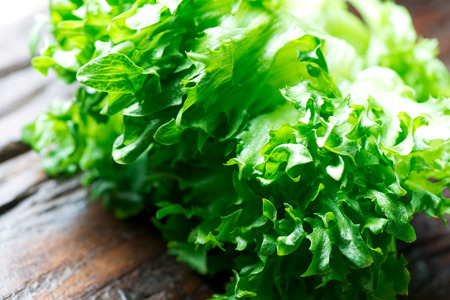 Fresh green lettuce on wooden tableの写真素材