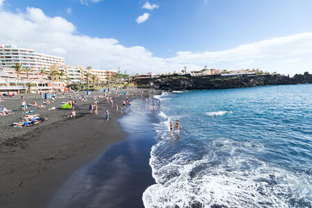 People at Black sand beach at Tenerife Island, Spainのeditorial素材