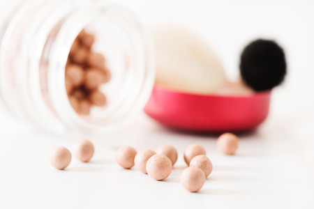 The bronzing pearls in jar and makeup brushの写真素材
