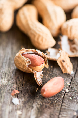 Peanuts in shell on wooden table