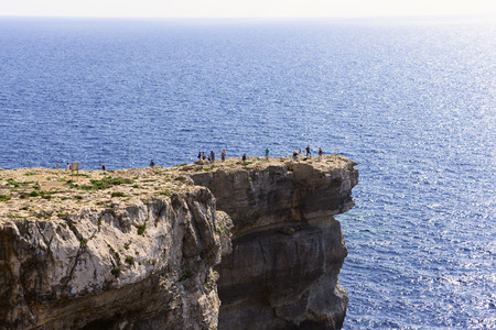 Tourists near Azure Window, famous stone arch of Gozo island in the sun in summer, Maltaのeditorial素材