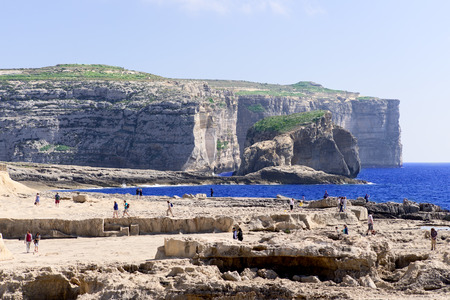 Tourists near Azure Window, famous stone arch of Gozo island in the sun in summer, Maltaのeditorial素材