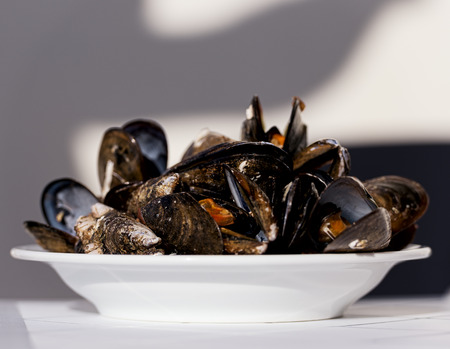 Gourmet mussels served garnished with fresh herbs for a tasty seafood meal