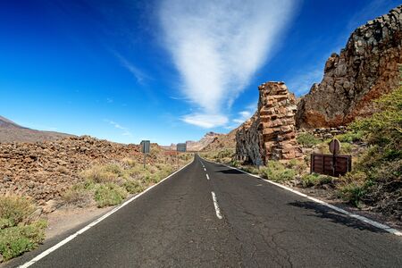 Asphalt road in high mountains near Teide Volcano at Tenerife Islandの写真素材