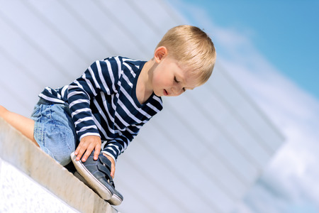 Portrait of little preschool boy outdoors.