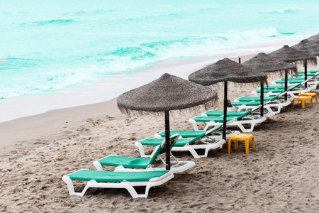 Sunbathing benches at beachの写真素材