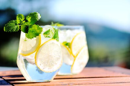 Lemonade in glass on wooden tableの写真素材
