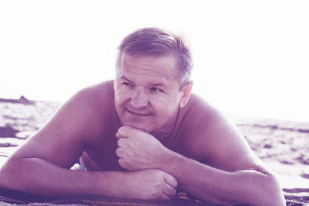 Man relaxing on sandy beach