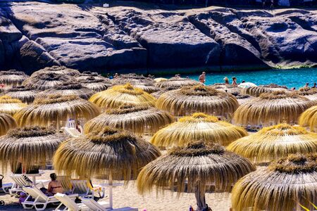 Straw umbrellas on Tenerife Island beachの写真素材
