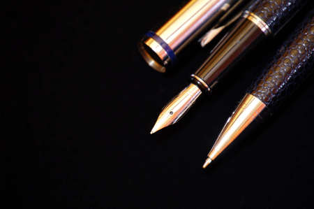 Classic nibbed fountain pen, on black background.の写真素材