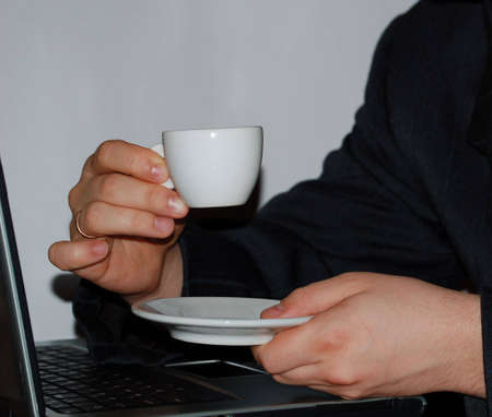 man in suit with cup of coffee