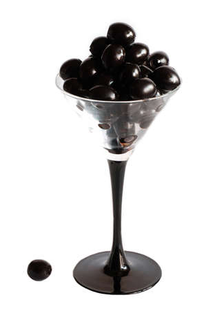 black olives in glass on white background isolatedの写真素材