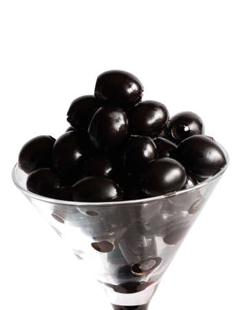black olives in glass on white background isolatedの写真素材
