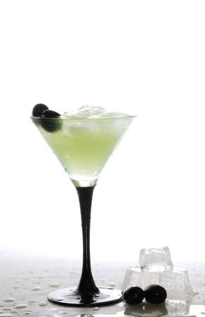 A cool iced drink,ice cubes and olivesの写真素材