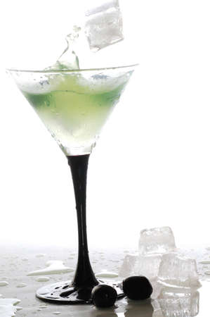 A cool iced drink,ice cubes and olivesの写真素材