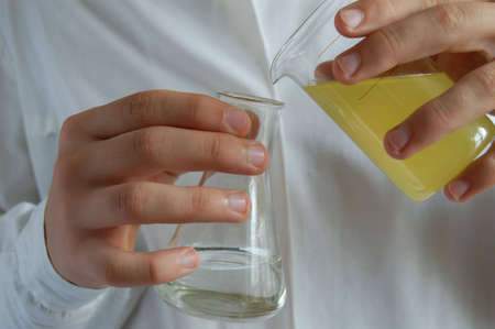 laboratory assistant with test tubes in handの写真素材
