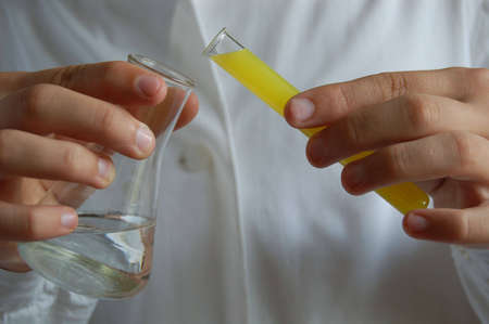 laboratory assistant with test tubes in handの写真素材