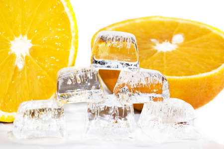 six ice cubes melted in water and slices of orangeの写真素材