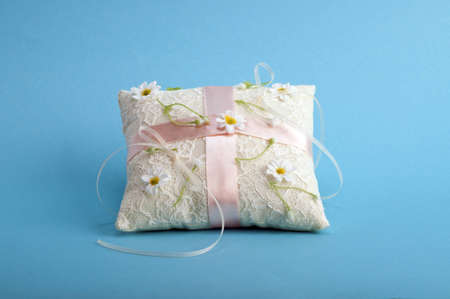 white pillow for wedding rings with flowerの写真素材