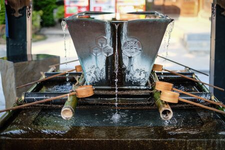 Close-up of Traditional bamboo water scoop in Japanese shrine.の写真素材