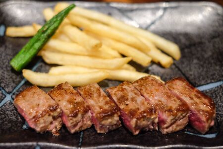 Grilled beef in oyster sauce with  green peppers and garlic on white plate.の写真素材
