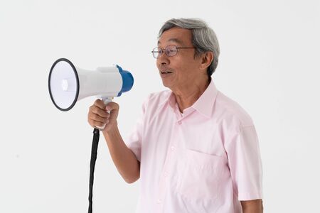 white studio portrait of senior asia retired elderly man shout loud announce by megaphone because need another hear his voiceの写真素材