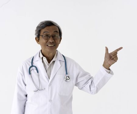 white background portrait of senior asia doctor point finger in the airの写真素材