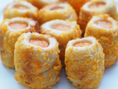 Chicken sausage roll made from bread with cheese sprinkles in small bite size