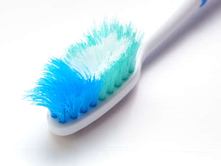 An old toothbrush with frayed bristles in the close-up view: time to change a new toothbrush for...