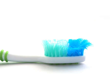 An old toothbrush with frayed bristles in the close-up view: time to change a new toothbrush for...