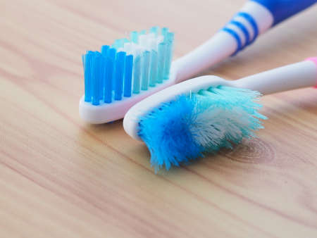 Comparison of the old and new toothbrushes showing different bristle conditions: time to change a new toothbrushの写真素材