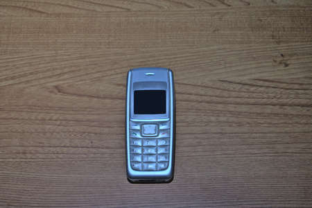 old gray cell phone with a numeric keypad and a small monochrome screen