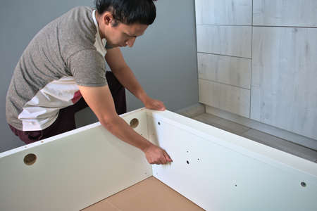 Man assembling the base of a double bedの写真素材