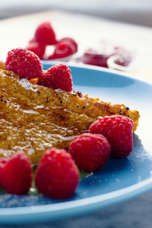 Raspberries on sugar and honey covered french toast