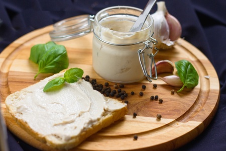 Meat pate in glass jar served with slice of breadの写真素材