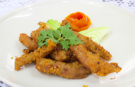 fried sliced neck pork with garlic and pepperの写真素材