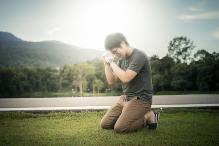 A man is praying to God on the mountain.