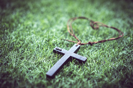 A mini cross on the grass.