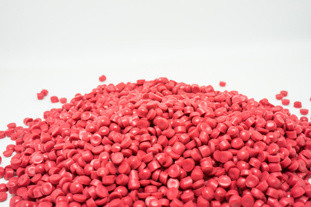 Red Plastic pellets. Colorant for plastics.の写真素材