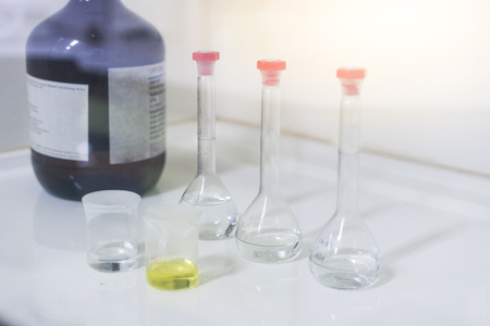 Scientists are preparing chemicals in fume hood.の写真素材