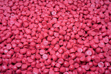 Red Plastic pellets. Colorant for plastics.の写真素材