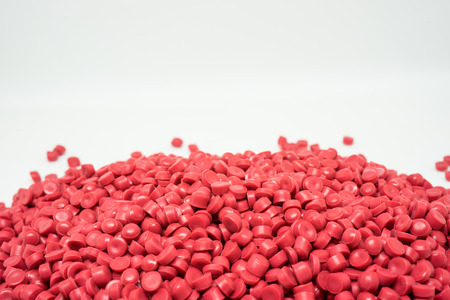 Red Plastic pellets. Colorant for plastics.の写真素材