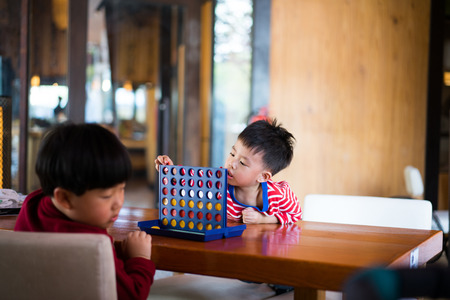 Brothers are playing a game together.の写真素材