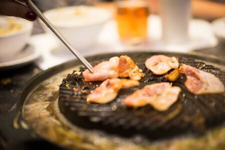 Bacons grill on the black pan.の写真素材
