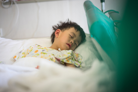 A sick boy is sleeping in the hospitalの写真素材