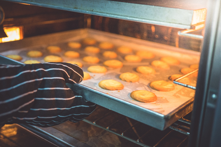 The chef is baking cookies with a large oven to prepare for sale.の写真素材