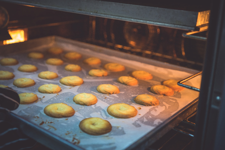 The chef is baking cookies with a large oven to prepare for sale.の写真素材