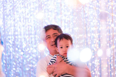 grandfather and grandson in the LED light infinity room, Family among the star concept.の写真素材
